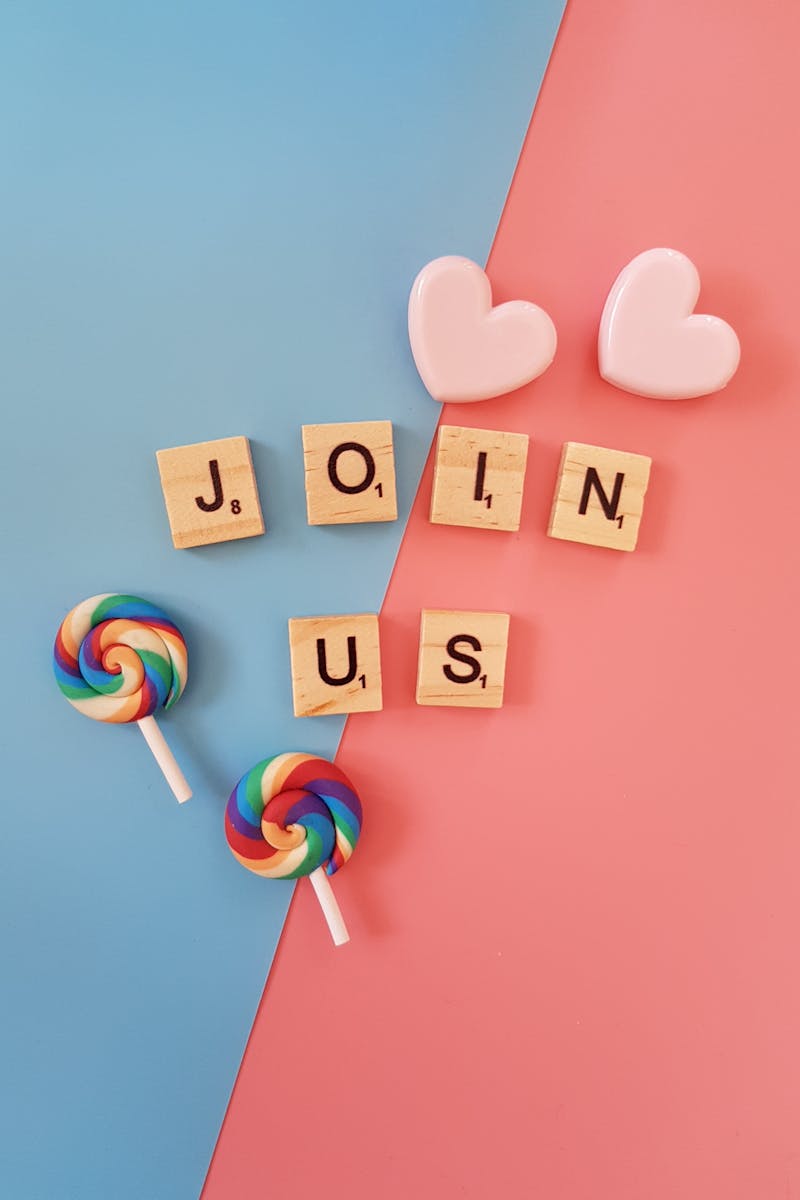 Bright 'Join Us' call-to-action with colorful lollipops and hearts on a pastel background.